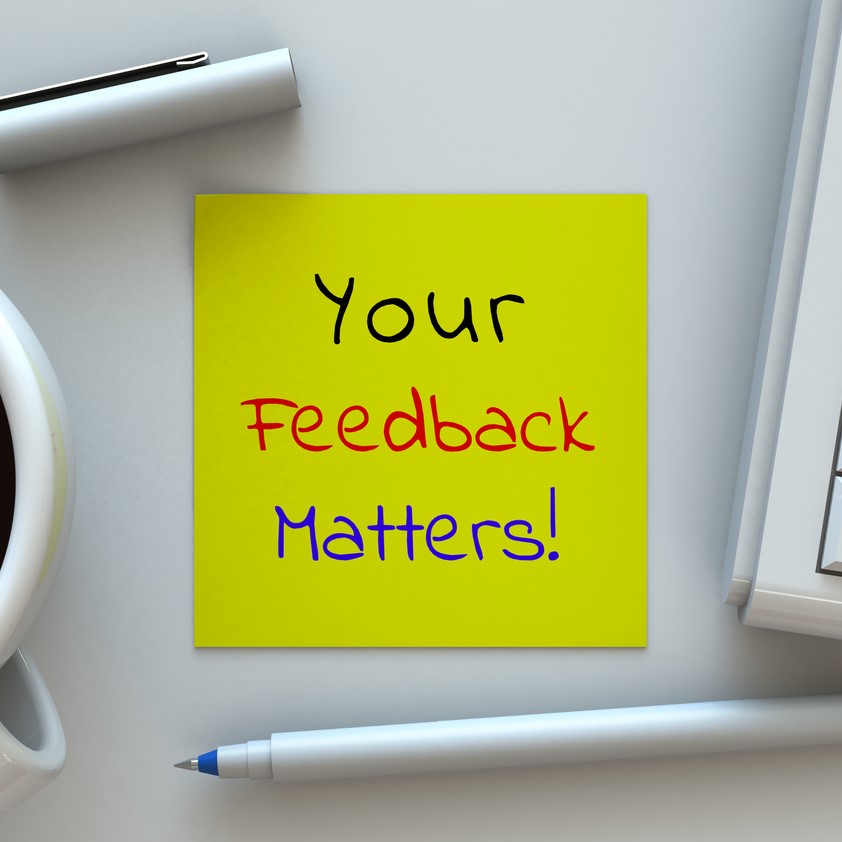 Your Feedback Matters, message on note paper, computer and coffee on table